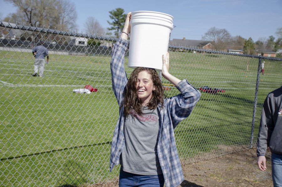 Bridgewater freshman and member of the women’s golf team Hannah Woodson carries a bucket of water on her head during the walk. 