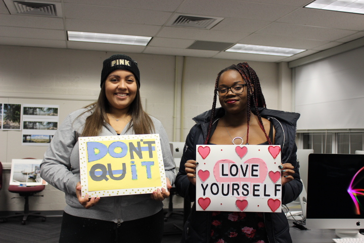 Senior Jazzlynne Miller (left) and Freshman Larissa Niles (right) are photographed with their works. They used their own creativity and new knowledge about visual design, obtained from the Gurus. 