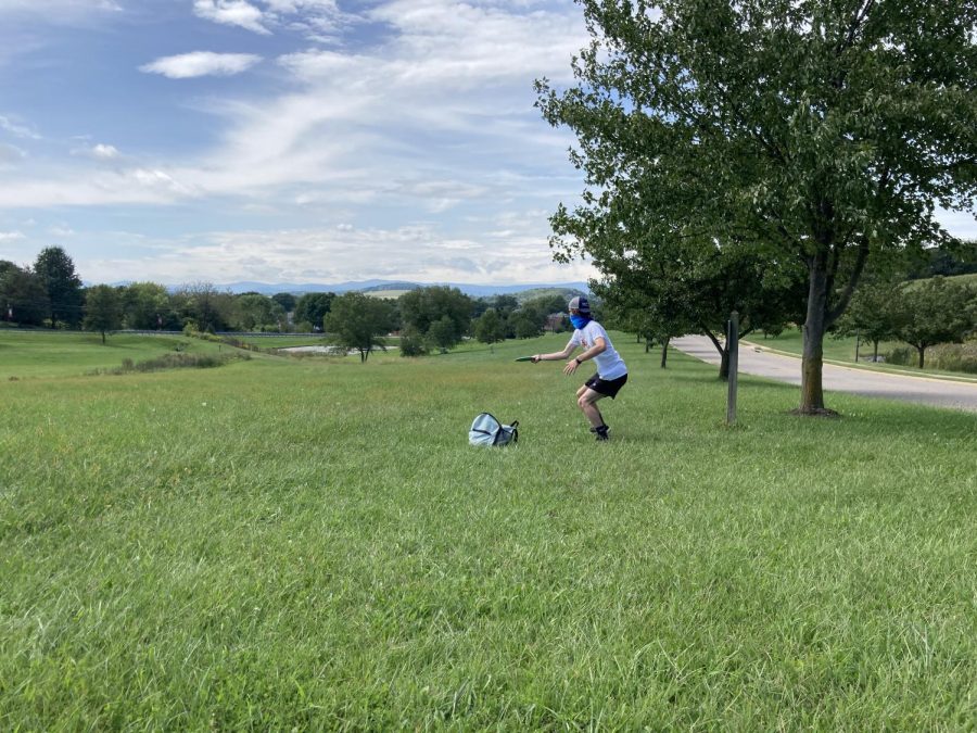 Sophomore Ben Riddle winds up to throw the disc to one of the longest holes on the course. To be a successful disc golfer the ability to keep the disc going straight is a priority, and Ripple controlled his throws throughout all nine holes.  