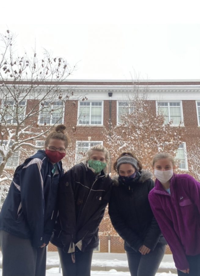 Students (pictured from left to right) first-year Summer Huber, sophomore Birttany Brookes, first-year Jenna Mccaffery, and first-year Maggie Hodnett took advantage of the snow day by spending time outside with one another.