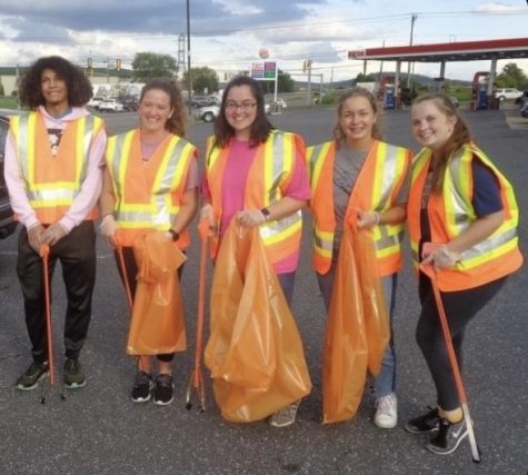 APO Volunteers to help pick up trash in the community