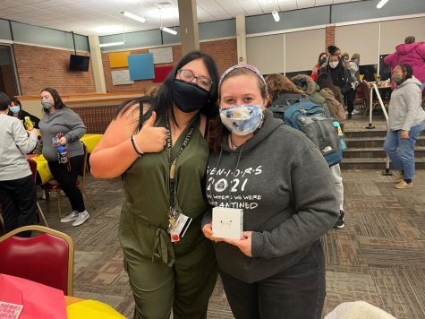 Sophomores Mae Lotts and Hayley Savage celebrate Savage’s first time win at bingo night.