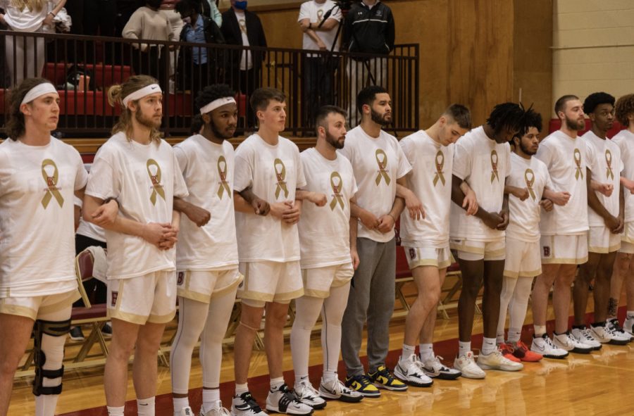 The+BC+mens+basketball+team+lined+up+and+linked+arms+as+the+stadium+give+a+moment+of+silence+in+honor+of+fallen+Officers+Painter+and+Jefferson