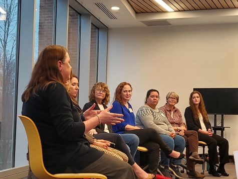 The panel members sitting at the front of the Great Room in the FLC. Featured in the front is Christine Andrews, who helped establish the breakthrough of the Pfizer vaccine.