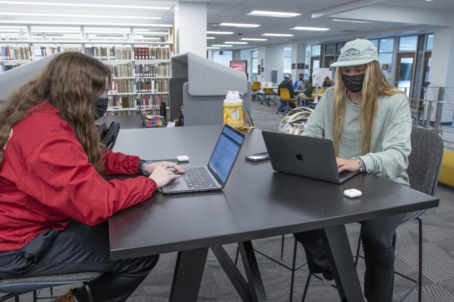 First-years Rachael Meyers and Daphne Daymude work on homework while wearing masks before the mask mandate is lifted.