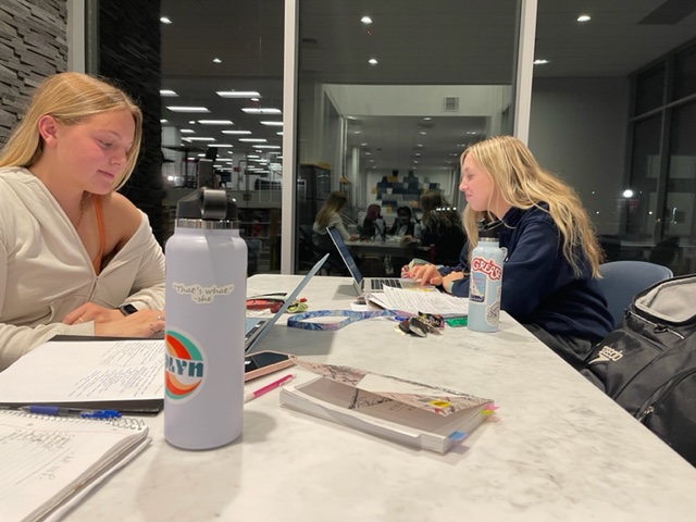 First-year Melia Ross and sophomore Isabelle Bauer doing homework without masks