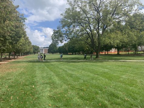 Students at a distance walk across the campus mall.