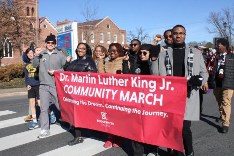 Bridgewater College students holding a sign saying Dr. Martin Luther King Jr. Community March