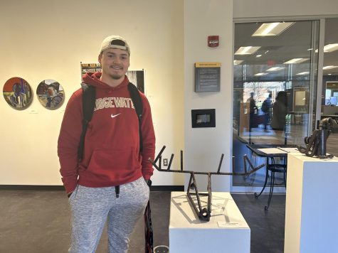 Timmy Ramberg stands with his metal sculpture titled “Deer Skull.” This is his first time contributing to an art show.