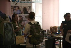 A student gathers around Brain Injury Connections’ booth, one of the service organizations tabling, to discuss volunteering.
