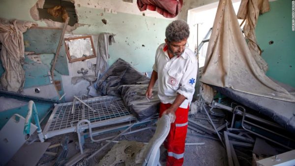Gazan medical professional surveys the damage after Israeli bombs destroy a hospital they believed to be the site of Hamas military materiel