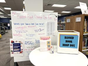 The banned book table in the FLC presents information on the recent county school’s book ban and senior Katelin Carter’s banned book fair. The ‘pay what you want’ event will take place on Thursday, April 4, from 4 p.m. to 7 p.m. in the FLC’s great room and is open to all students, faculty and community members.