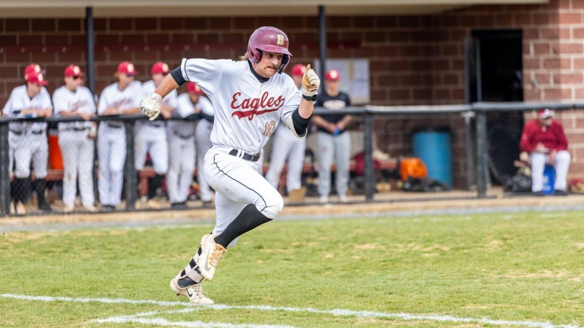 Junior Lucas Bauer runs to get on base for the Eagles. The Eagles had 4 players get at least two hits during the game.