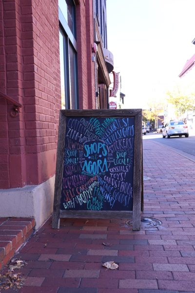 A sign welcomes guests to the Agora Downtown Market, also known as the Shops at Agora, located on South Main Street in the heart of downtown Harrisonburg. The marketplace features a community of small, local businesses including Great.Full Goods, Lineage, Bougie Hippie, Heartworn Vintage, Broad Porch Coffee Co. and more!