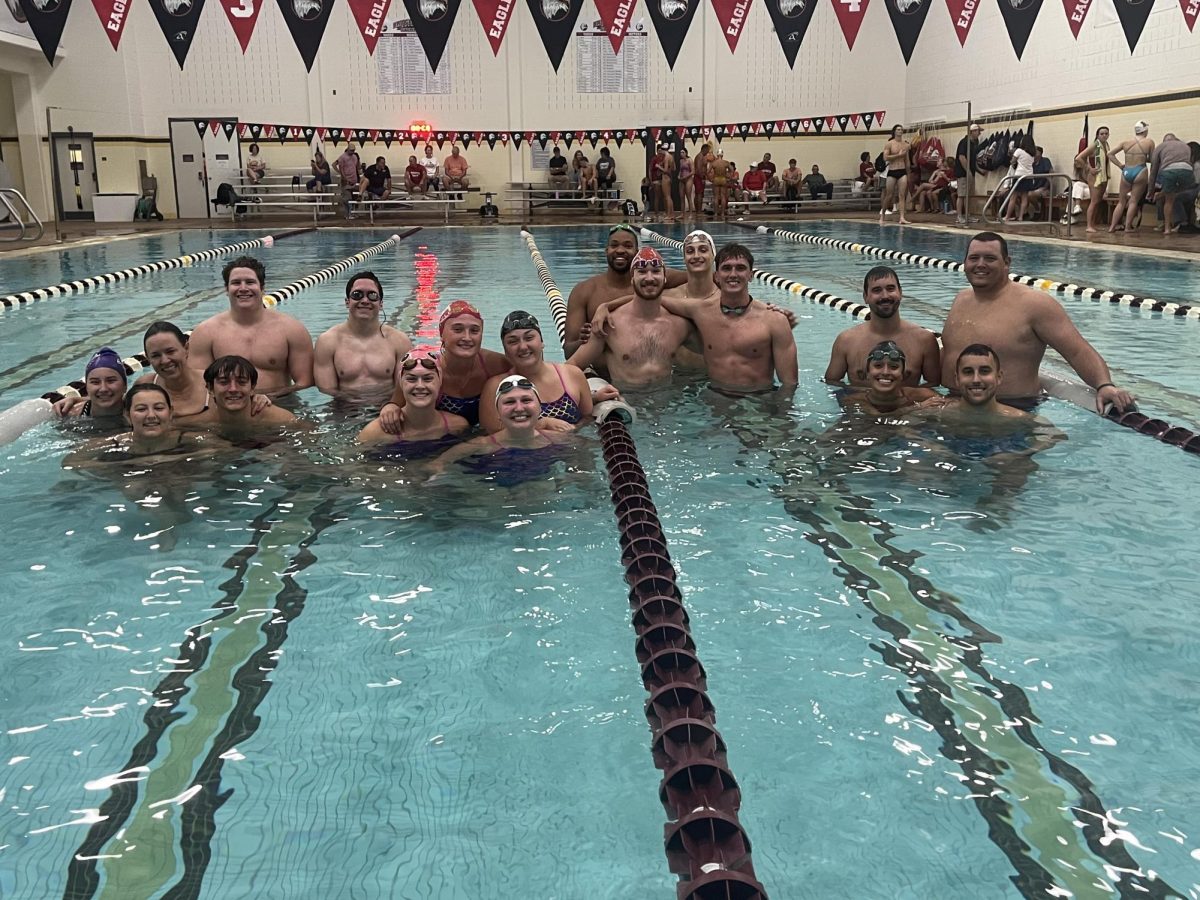 The families of four swimmers took a photo together after the events were complete. There were eight families that participated in the relays and two groups of Bridgewater Alumni.