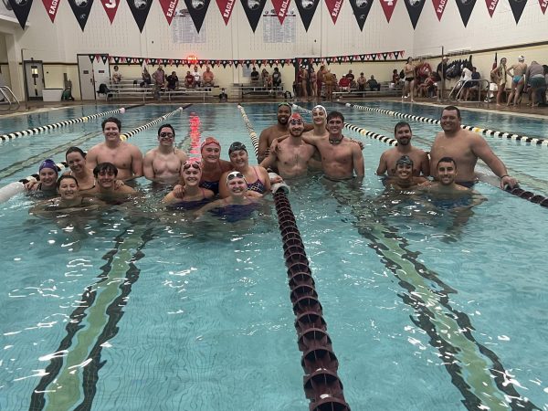 The families of four swimmers took a photo together after the events were complete. There were eight families that participated in the relays and two groups of Bridgewater Alumni.