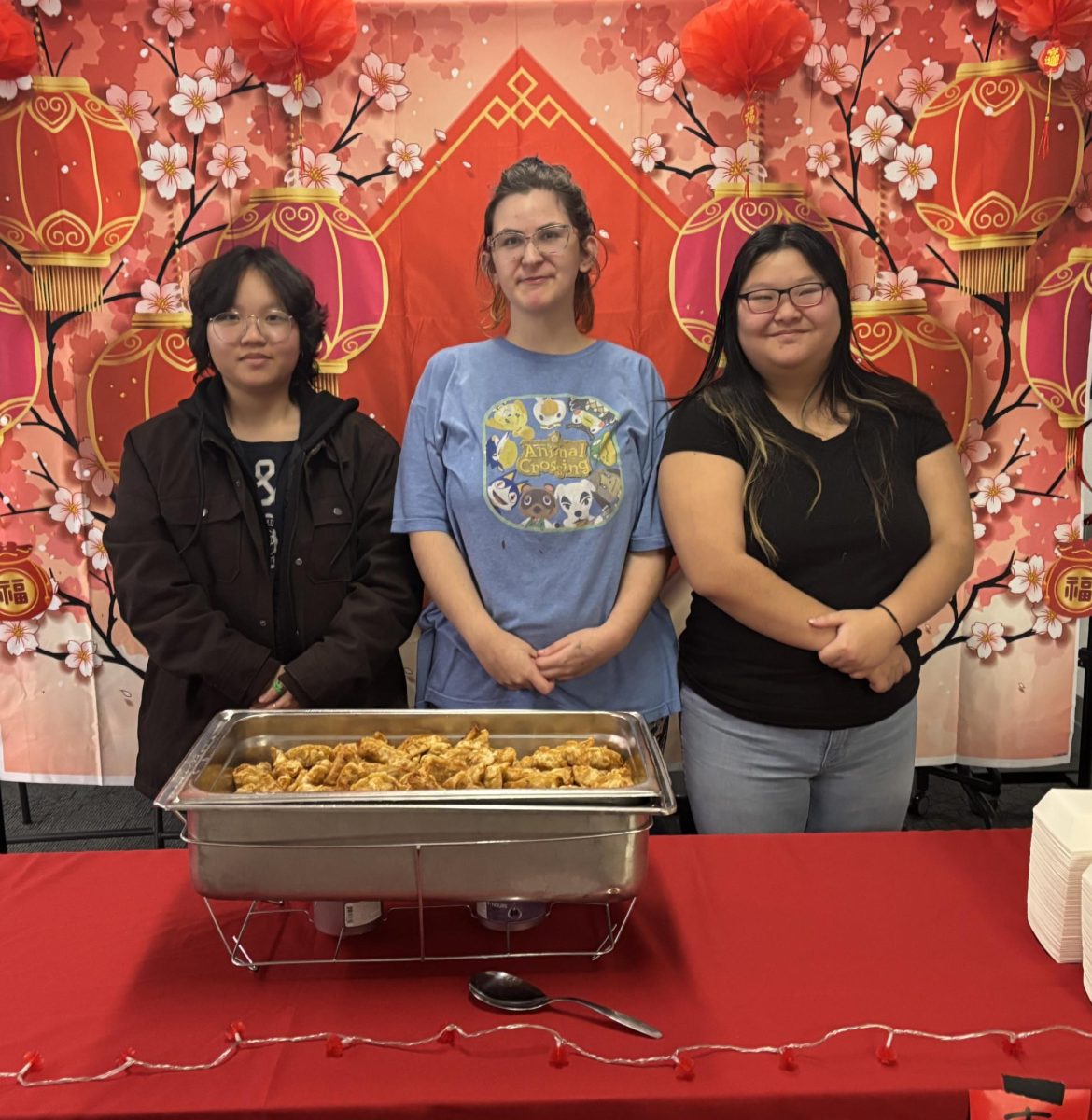 ASA Vice President Chu Zhou, Event Coordinator Keoki Phillips, and President June Holm stand together prior to the Bridgewater College’s Journey of Lights celebration. ASA participated in the Journey of Lights Celebration Thursday, Dec. 5 by talking about the Dongzhi Festival and sharing food.