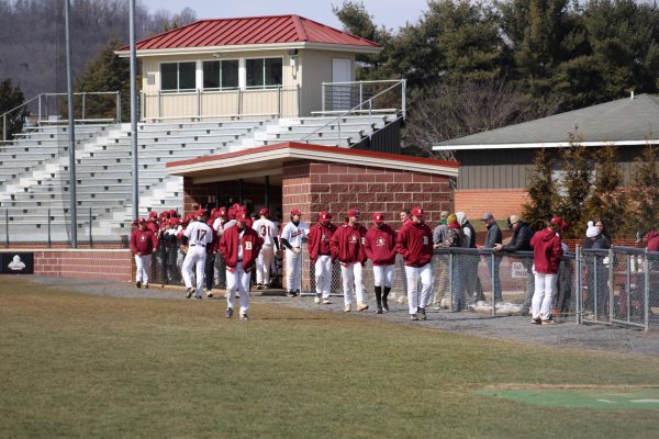 Bridgewater College’s baseball team gathers in the dugout before taking the field in their matchup against McDaniel College. Prior to this game, Bridgewater had never beaten McDaniel, losing their last two meetings by just two runs.