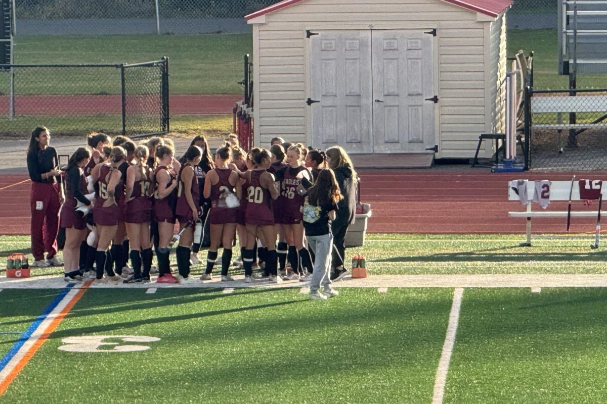 Coach Emily Bagby talks to her team after a 2–0 victory over Virginia Wesleyan. This huddle allows them to focus on momentum for the next match. 