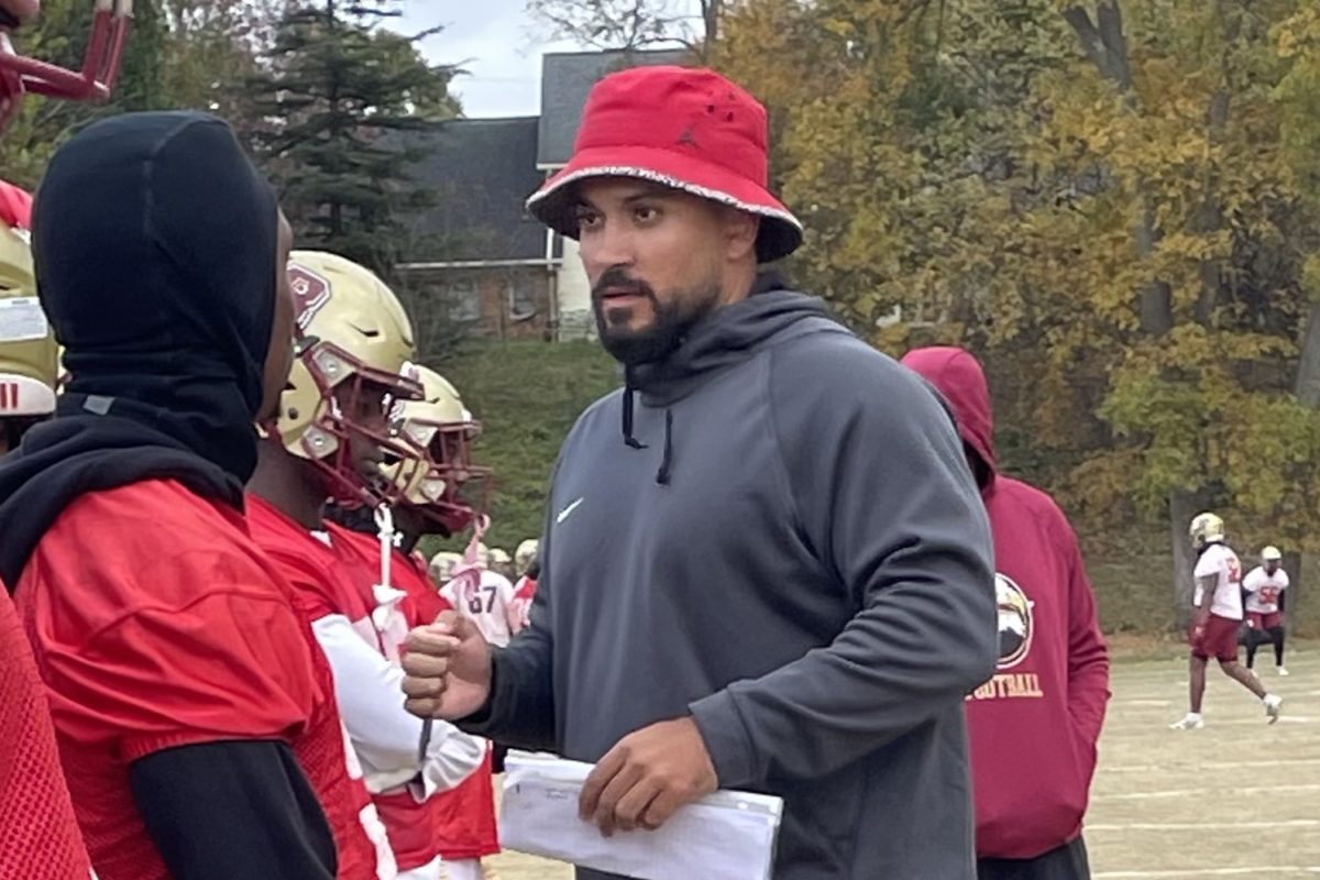 Coach Dustin Green listens as one of his players asks a question during a competitive team period. Green prides himself on balancing high energy and intensity with the ability to calmly break down plays and explain the scheme.