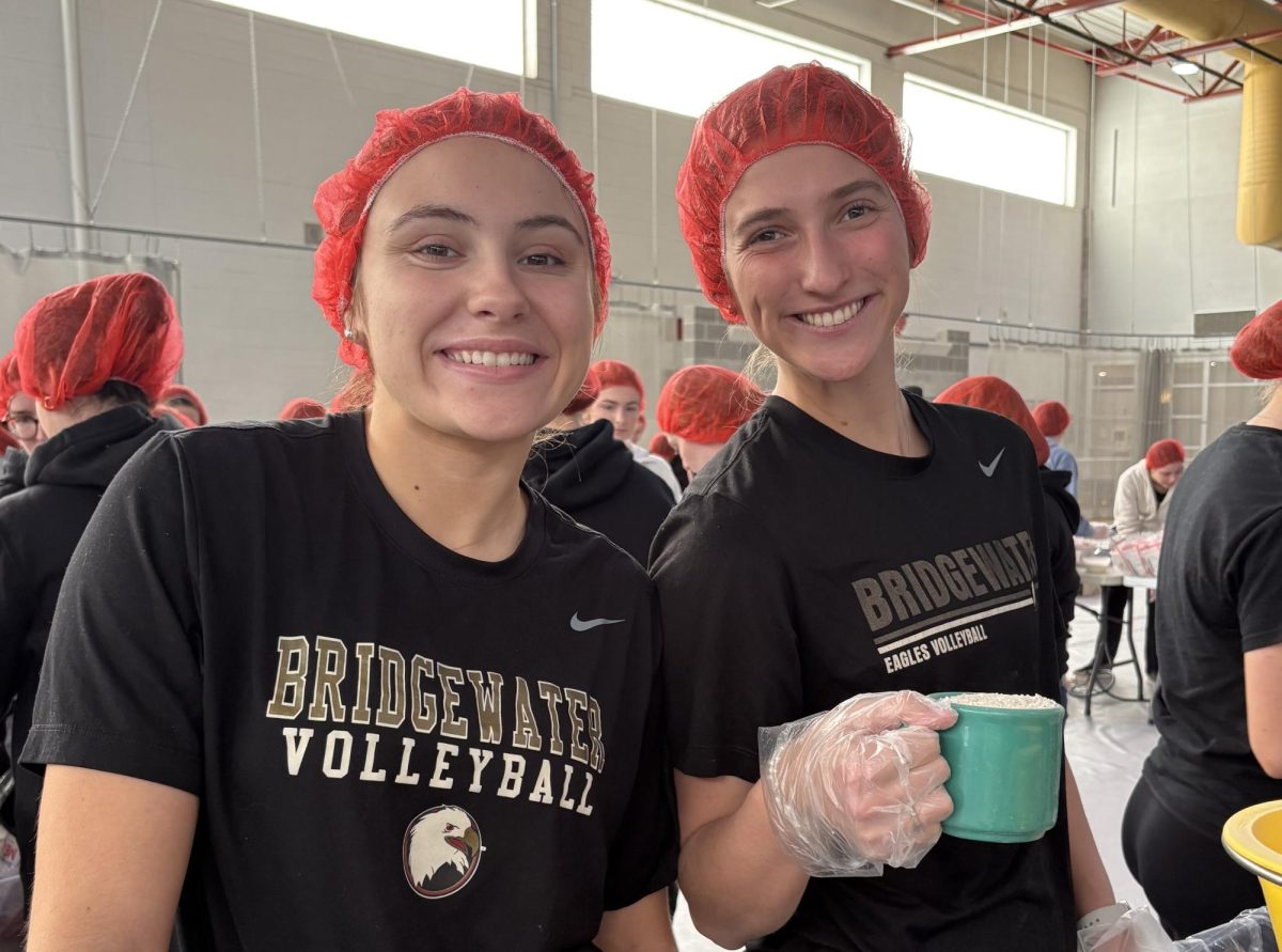 Bridgewater College Women’s Volleyball players Maya Veselinovic (left) and Jillian Levin (right) work together to package rice, wheat, soy and various vitamins for RISE Against Hunger. These meals will go to people around the world suffering from food insecurity.