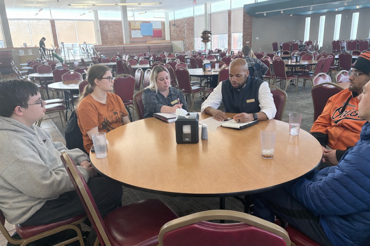 Students meet with manager Adrian Taylor and assistant director of operations Natalie Korinko to listen to other students' concerns, comments and requests submitted via virtual comment card.