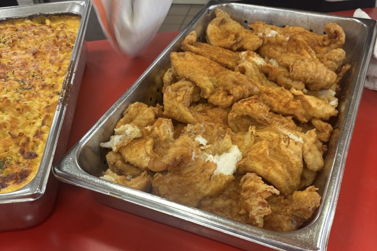 Fried catfish and mac and cheese sit on display in the main dining hall during the Black Student Alliance’s Jamaican-themed takeover on Feb. 10. The dishes were among the featured menu items for the event.