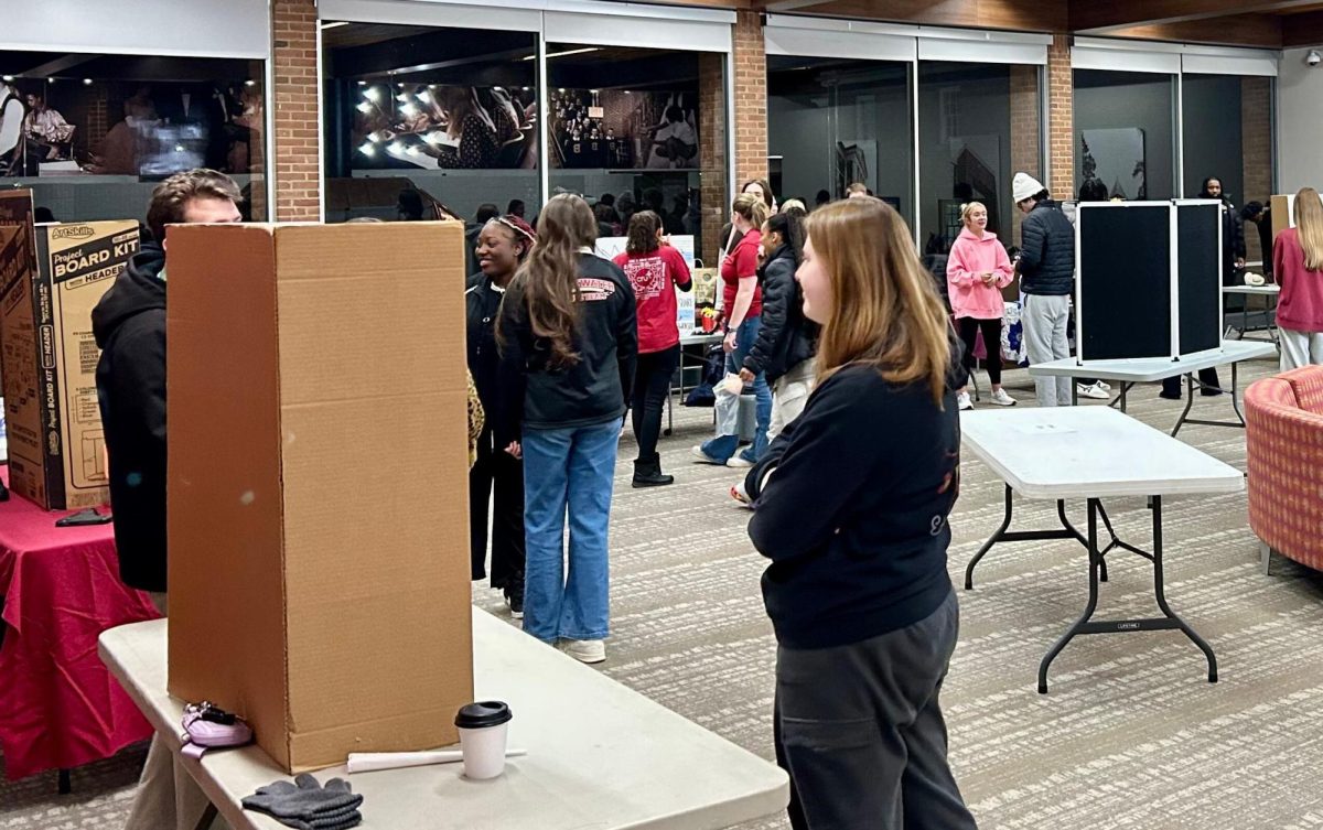 Students gather around to look at potential opportunities to join clubs for the spring semester. Clubs are giving their pitch to curious students about their organization.
