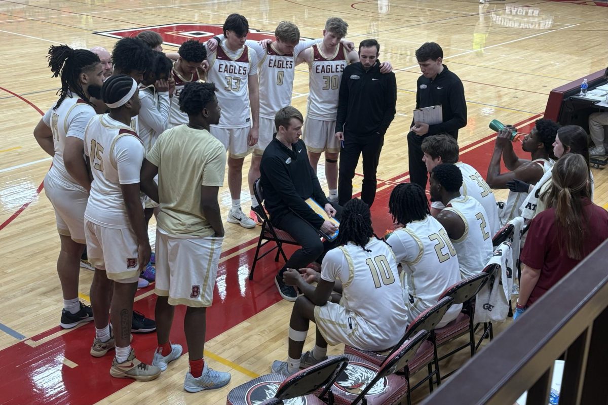 Bridgewater players gather during a timeout as the Eagles look to regroup against Guilford on Jan. 17. The huddle came during a difficult stretch in the game as the team worked to adjust to Guilford’s defensive pressure.