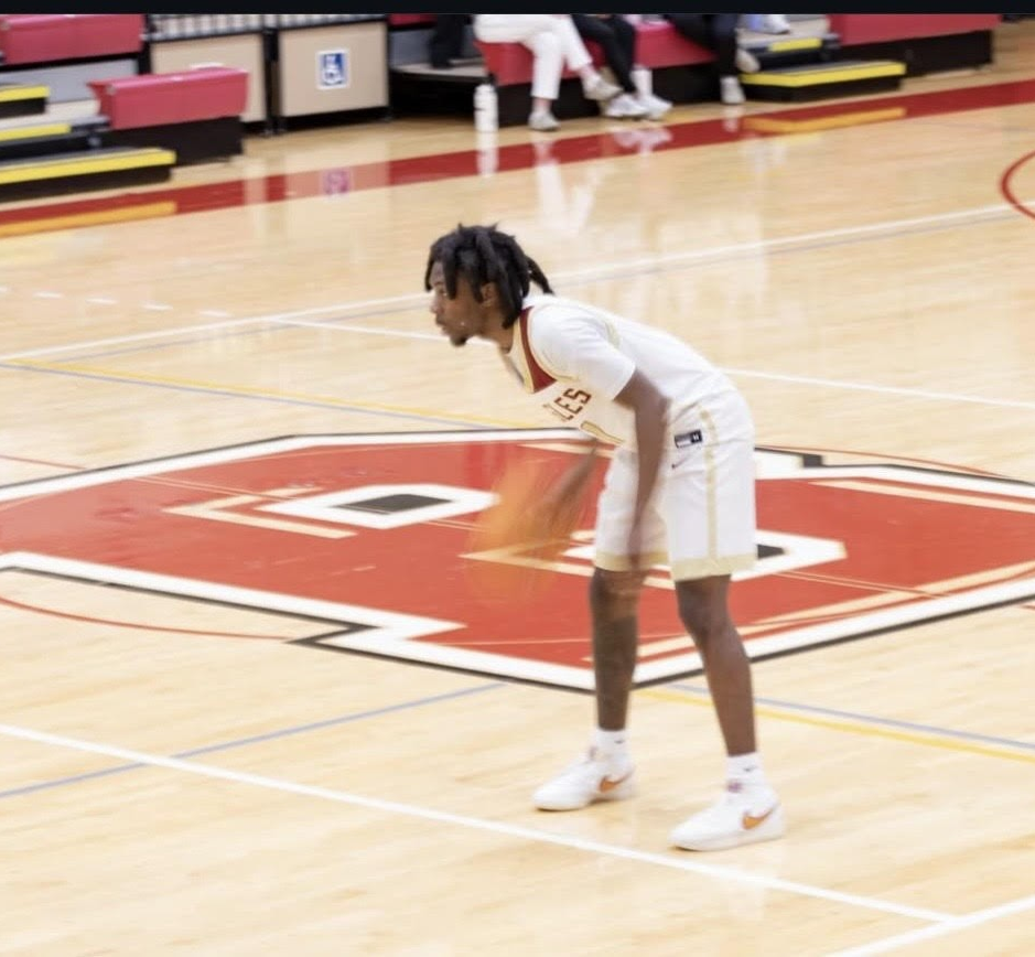 Junior Guard Mi’Kis Engram dribbles the ball while running his offense. Engram scored 3 points and recorded 2 assists against the Marlins. Photo by: Sarah Maggi