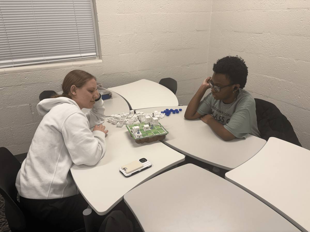 Jakiyah Moyker playing a board game with her friend. She left with a good impression of the club