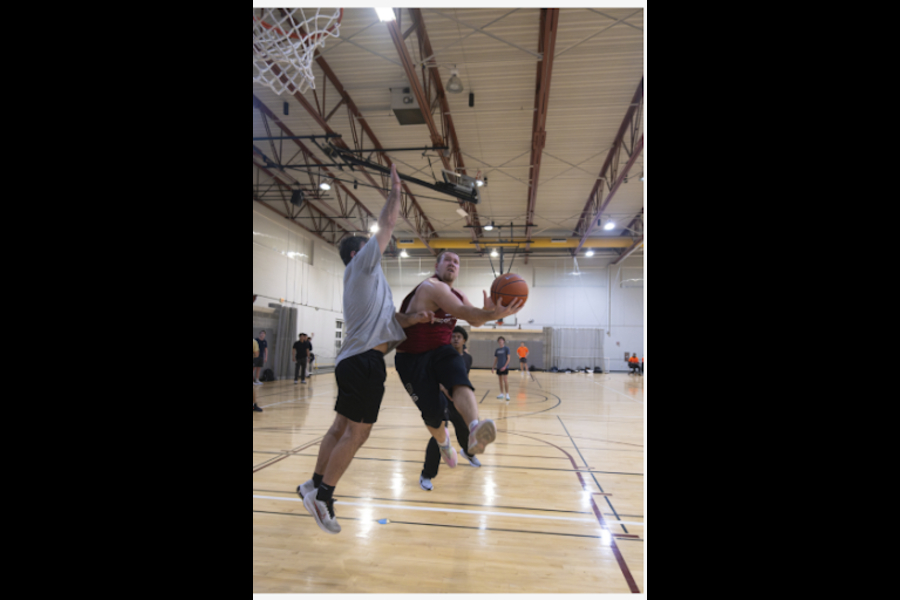 Intramural basketball, Charlie Bratburd weaving his way through defenders to convert on the layup. Bratburd and the Big Cats won their game Wednesday night against the Edgers to close out the regular season. 